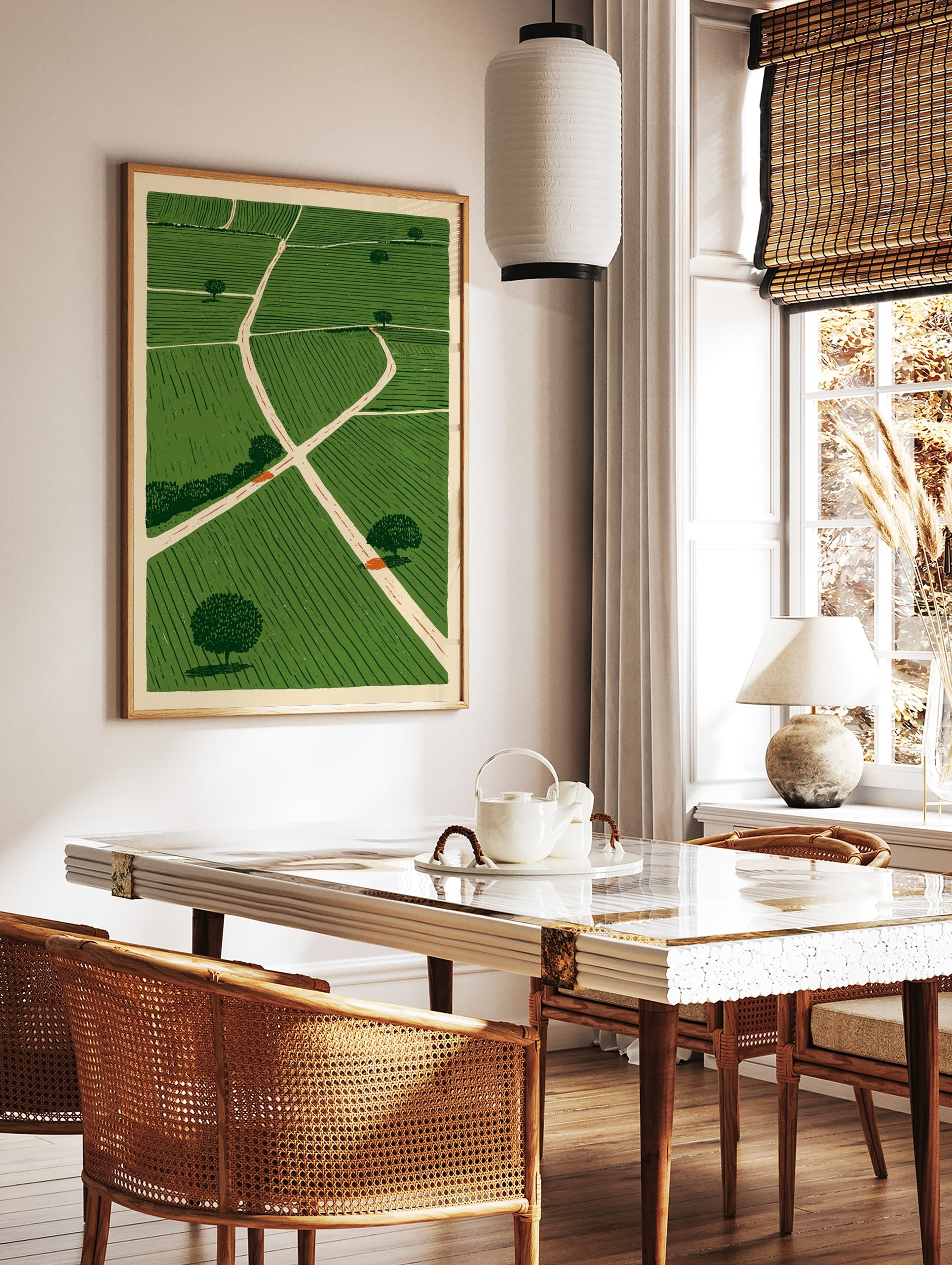 Illustrative green fields landscape wall art with intersecting paths and scattered trees on a, in a styled room mockup