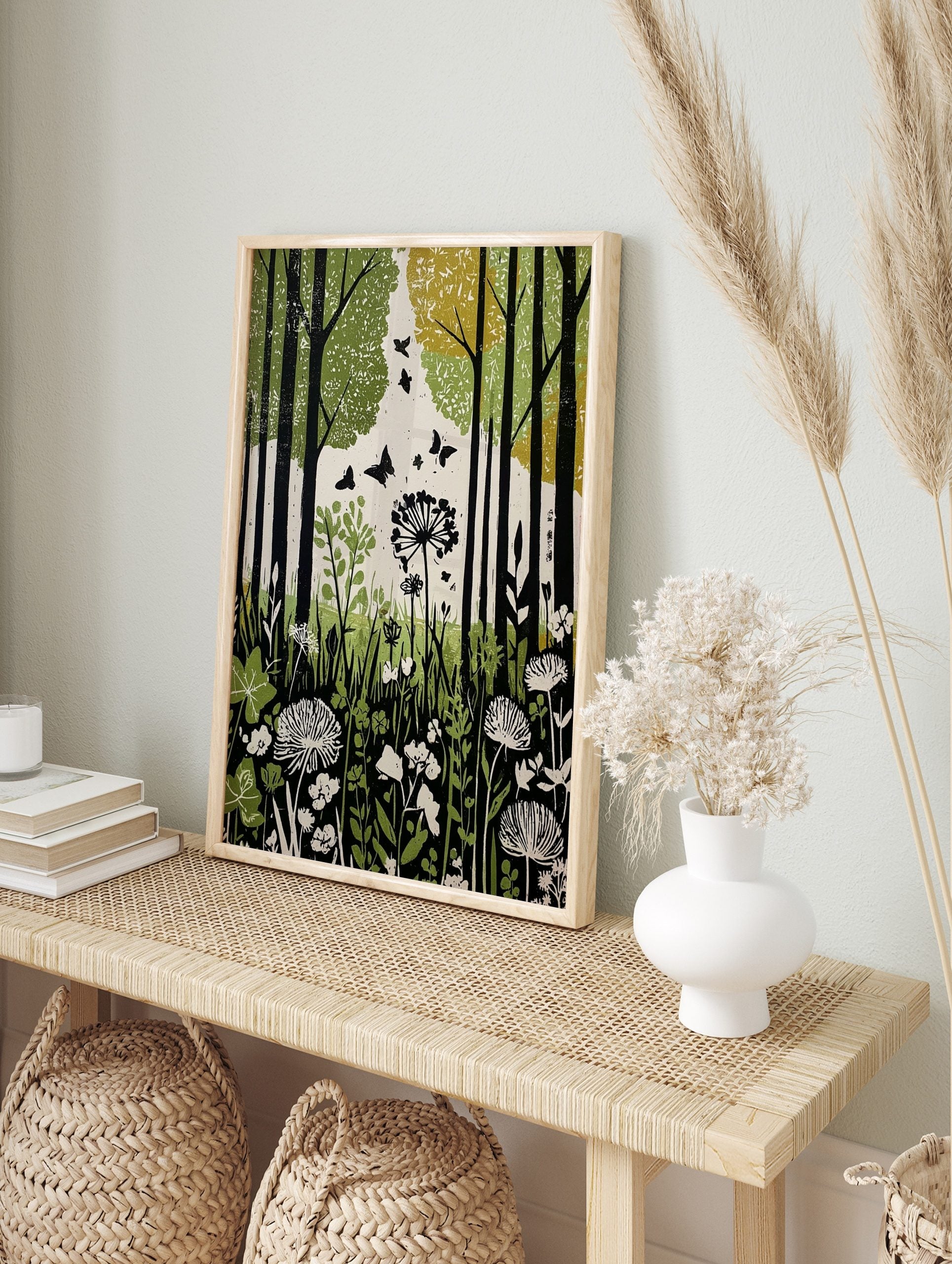 Green forest botanical print with black tree trunks, flying butterflies, and white, in an alternate framed mockup
