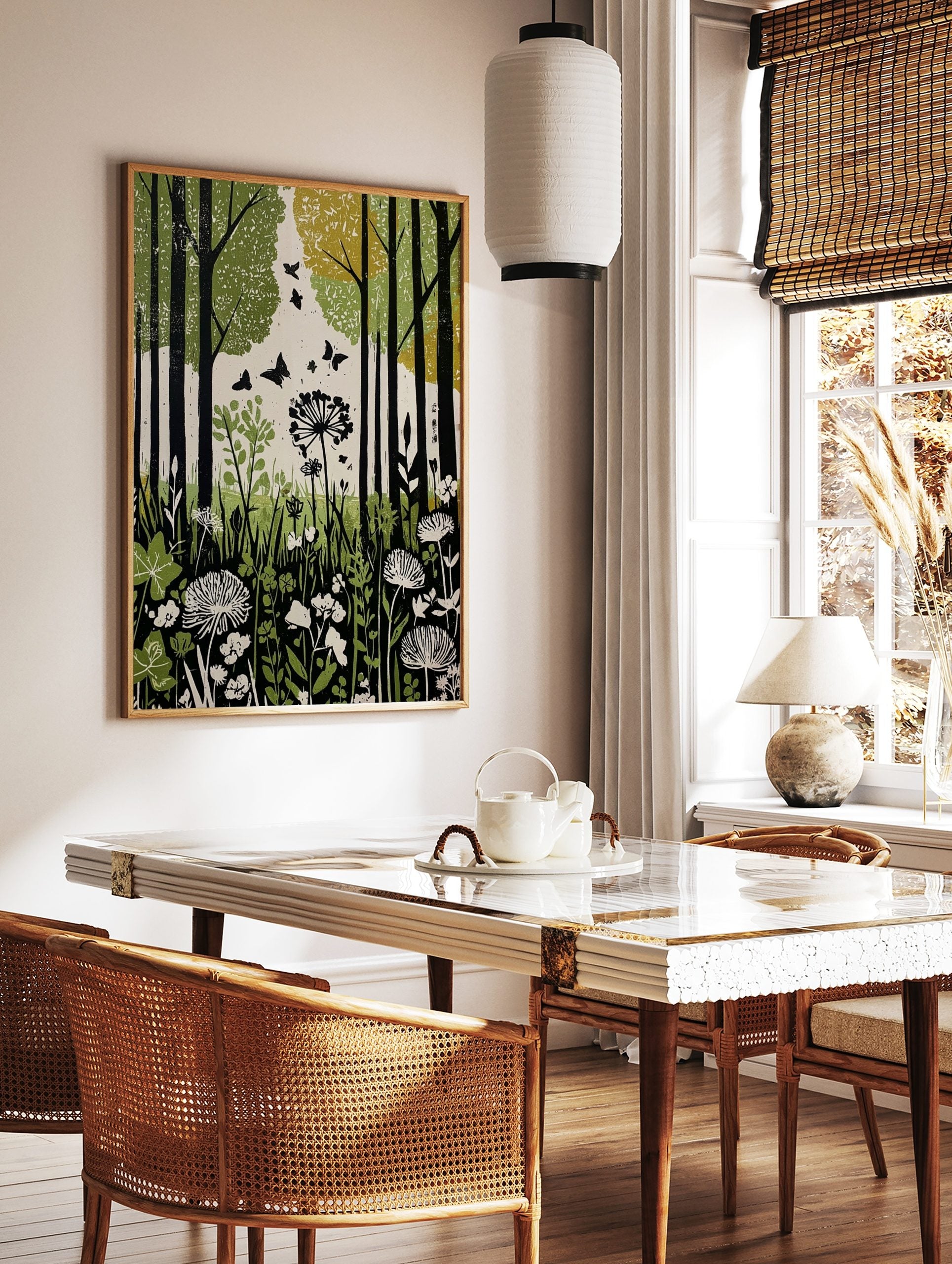 Green forest botanical print with black tree trunks, flying butterflies, and white wildflowers in, in a styled room mockup