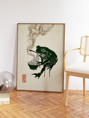 Stylized green frog eating ramen noodles with chopsticks, with steam rising, on a textured beige background. Green Frog Ramen Wall Art. - Image 2