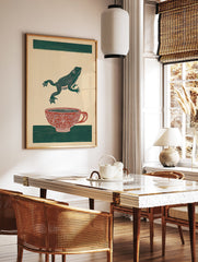 Green frog leaping over a red patterned teacup on a beige background with green stripes. Frog art print. - Image 3