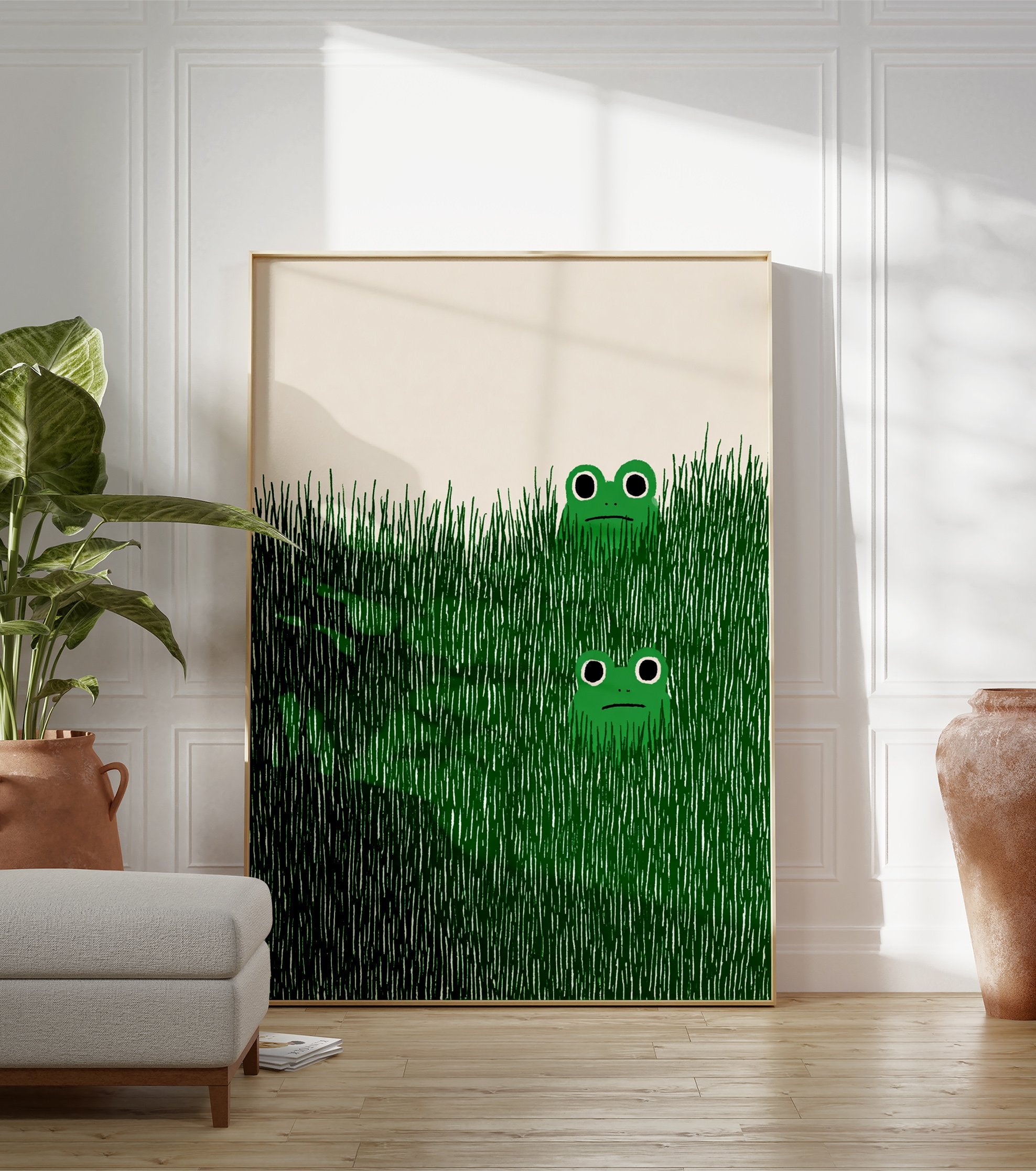 Illustrative green frog wall art print showing two cartoon frogs peeking from tall green grass on a light background. - Image 3