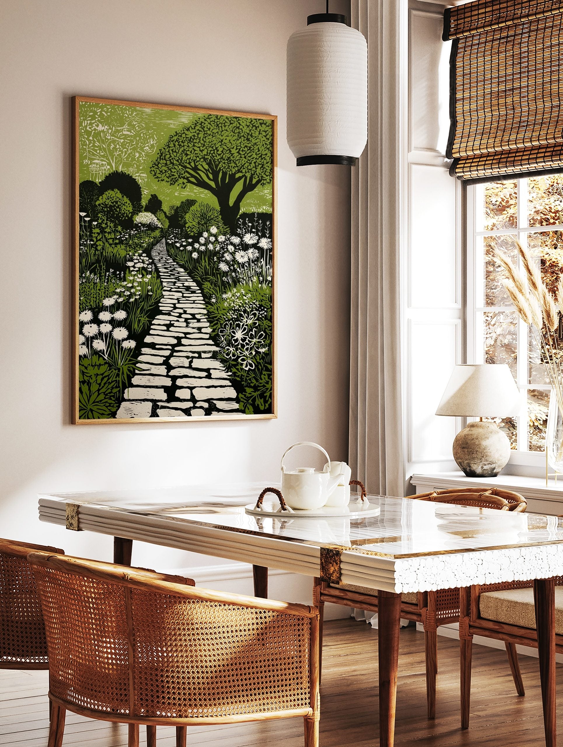 Green and black linocut print of a winding stone garden path surrounded by white flowers and lush, in a styled room mockup