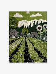 Green garden linocut-style print with vegetable rows, barns, sunflowers, mountains, and sun in sky