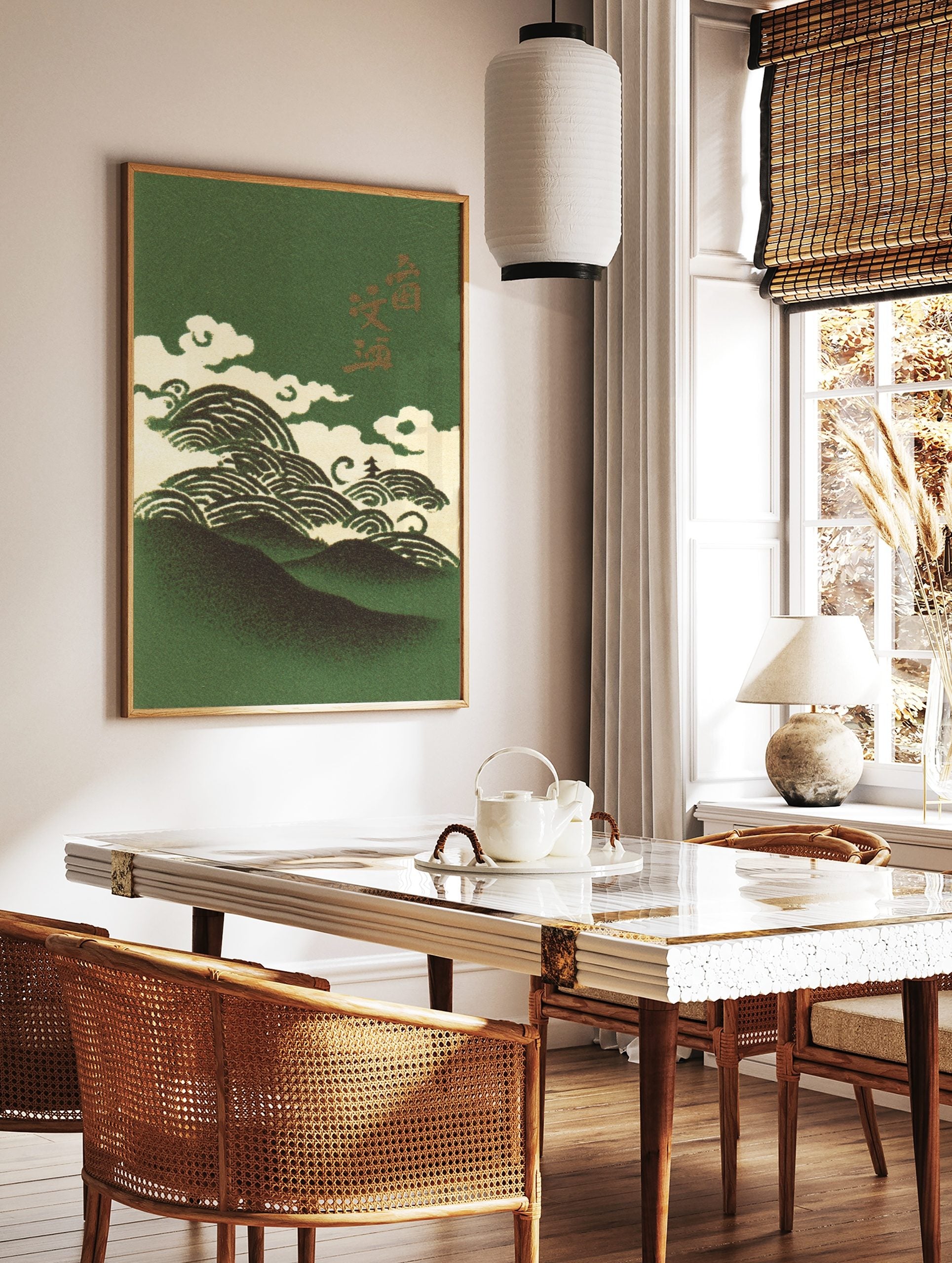 Illustrative Japanese art print with dark green mountains, cream waves, clouds, and gold kanji, in a styled room mockup