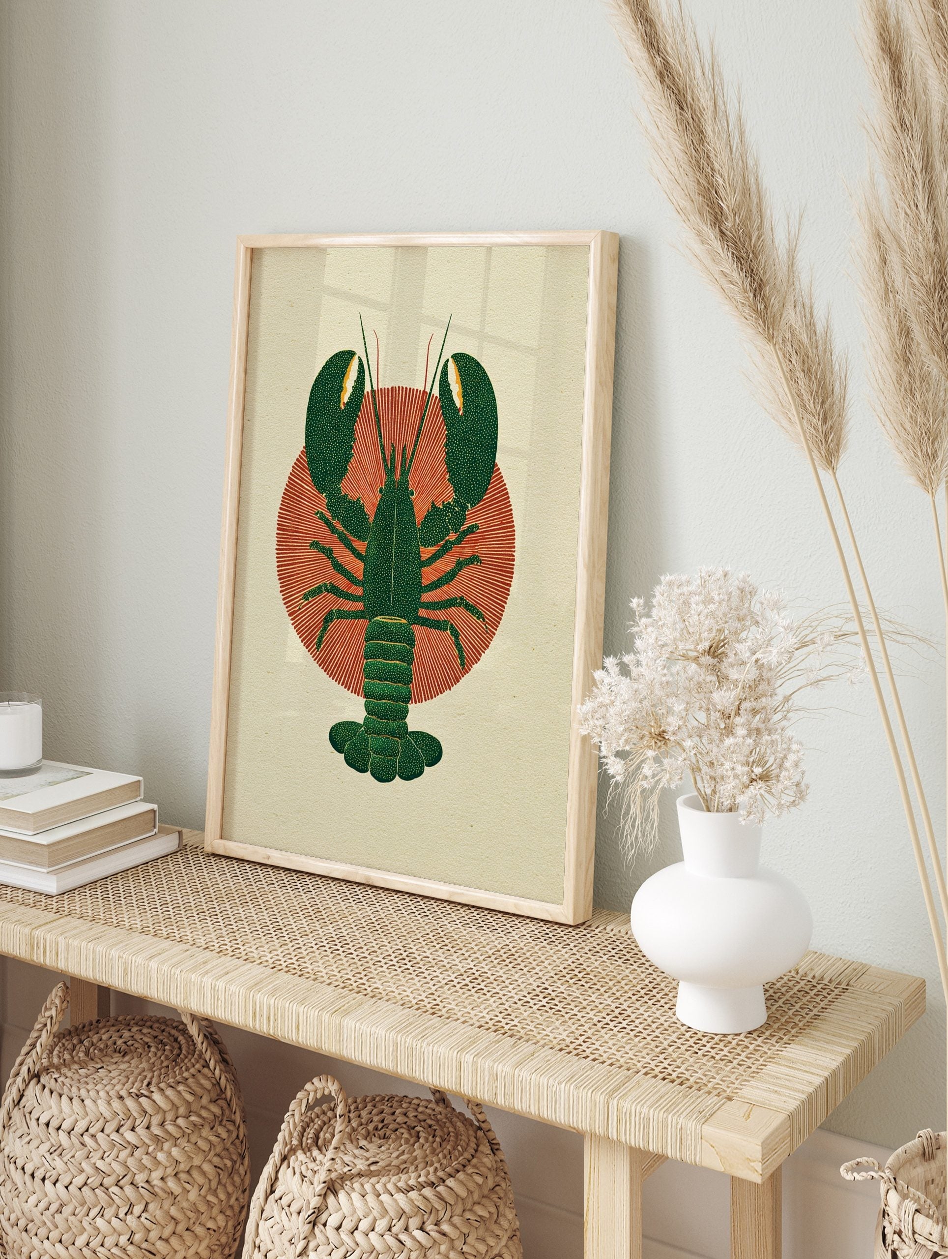 Dark green lobster illustration with textured claws and tail on a red radial sunburst, in an alternate framed mockup