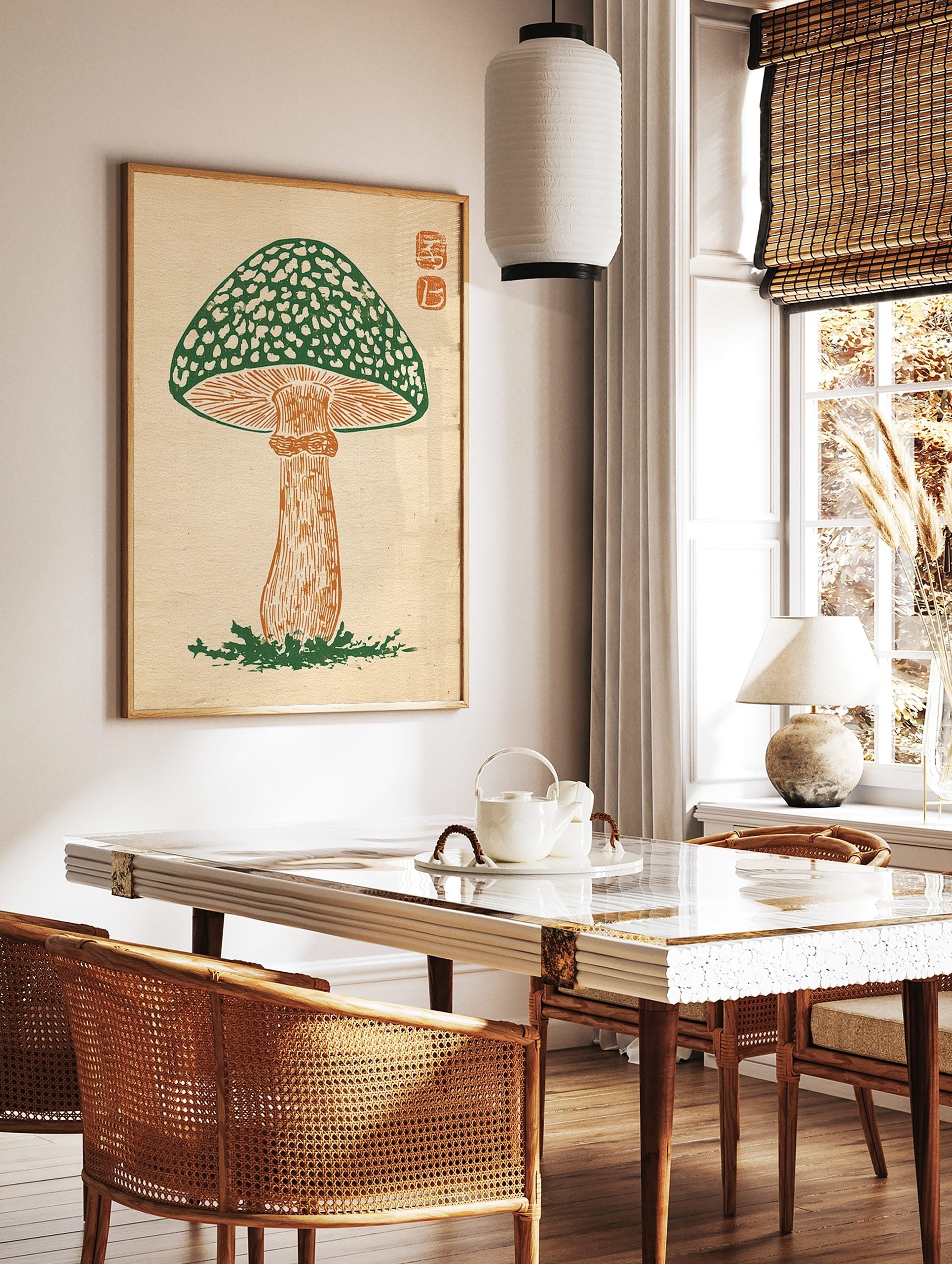 Green mushroom woodcut print with spotted cap, orange stem, and two square seals in the top right, in a styled room mockup