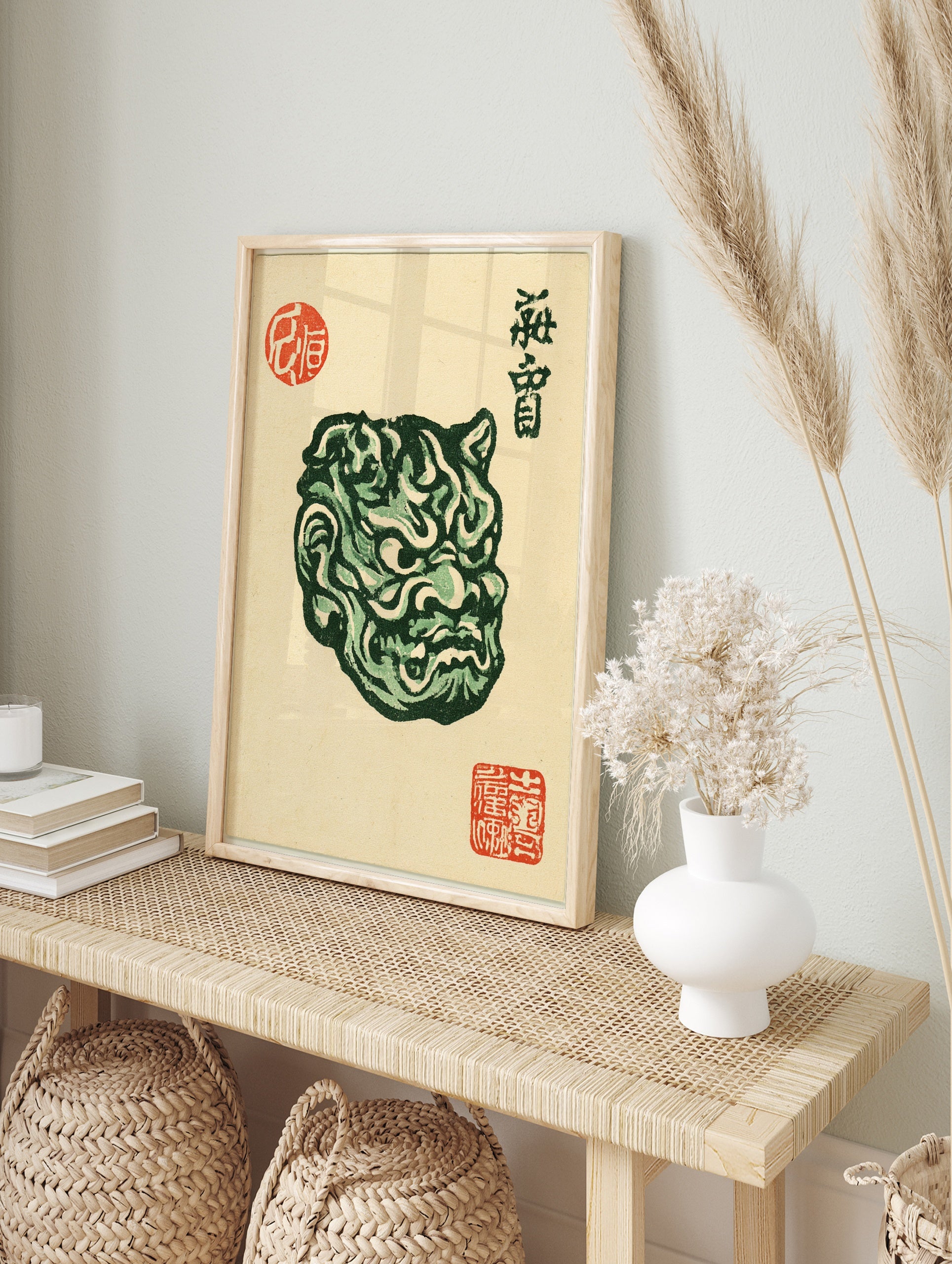 Detailed green Japanese Oni mask illustration with red artist stamps on a light beige, in an alternate framed mockup