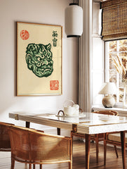 Detailed green Japanese Oni mask illustration with red artist stamps on a light beige background, in a styled room mockup