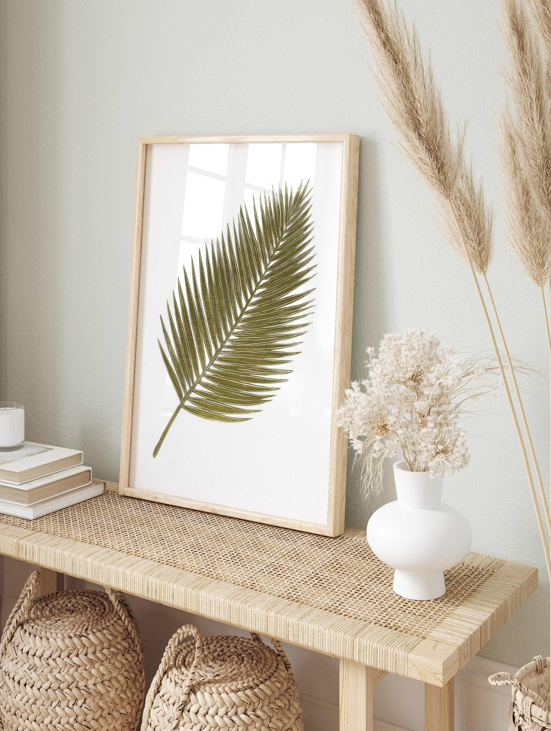 Green palm leaf botanical illustration art print with white outlines on a white background, in an alternate framed mockup