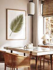 Green palm leaf botanical illustration art print with white outlines on a white background, in a styled room mockup