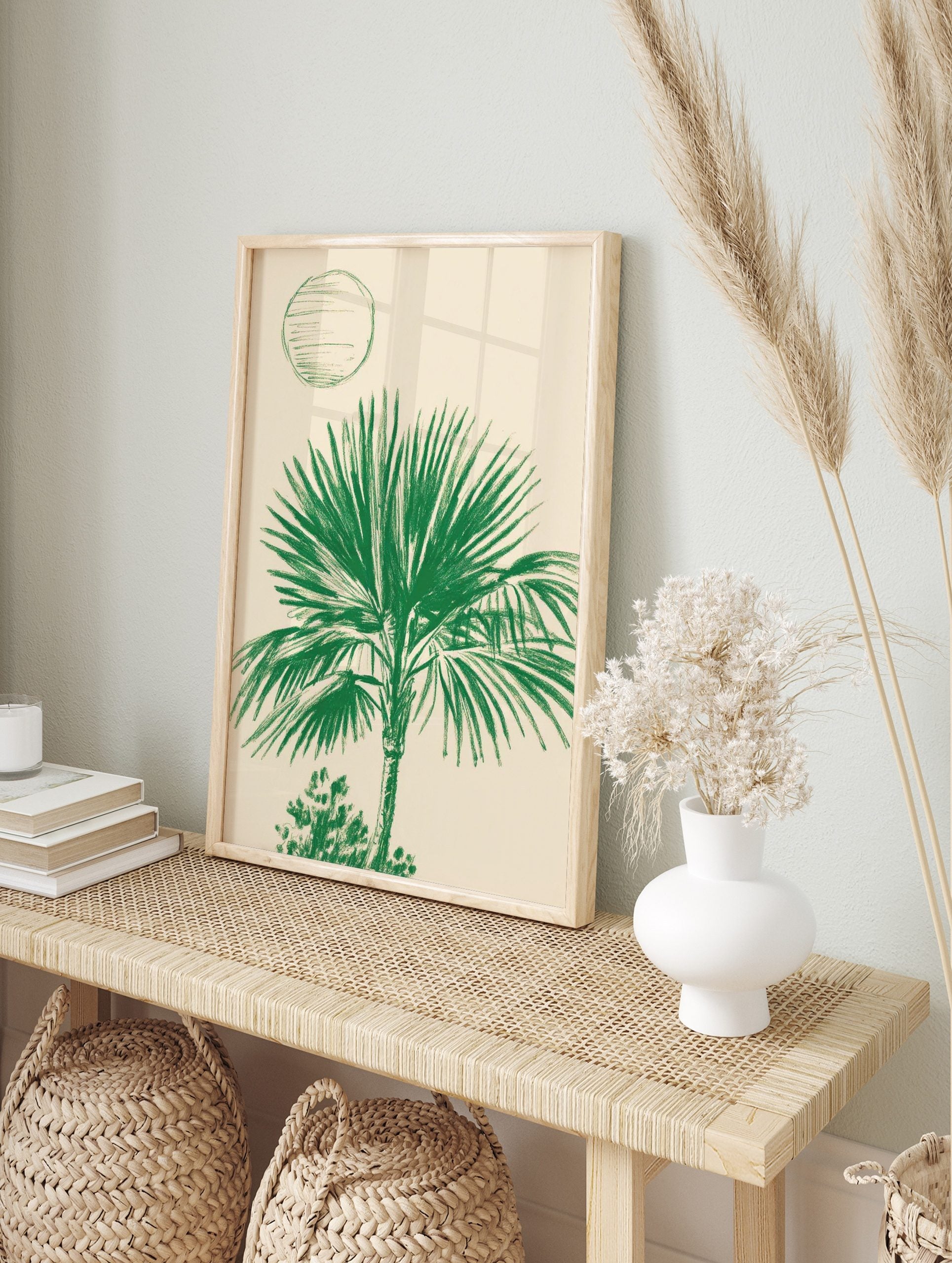 Illustrative green palm tree art print with broad fronds and an abstract circle on a light, in an alternate framed mockup