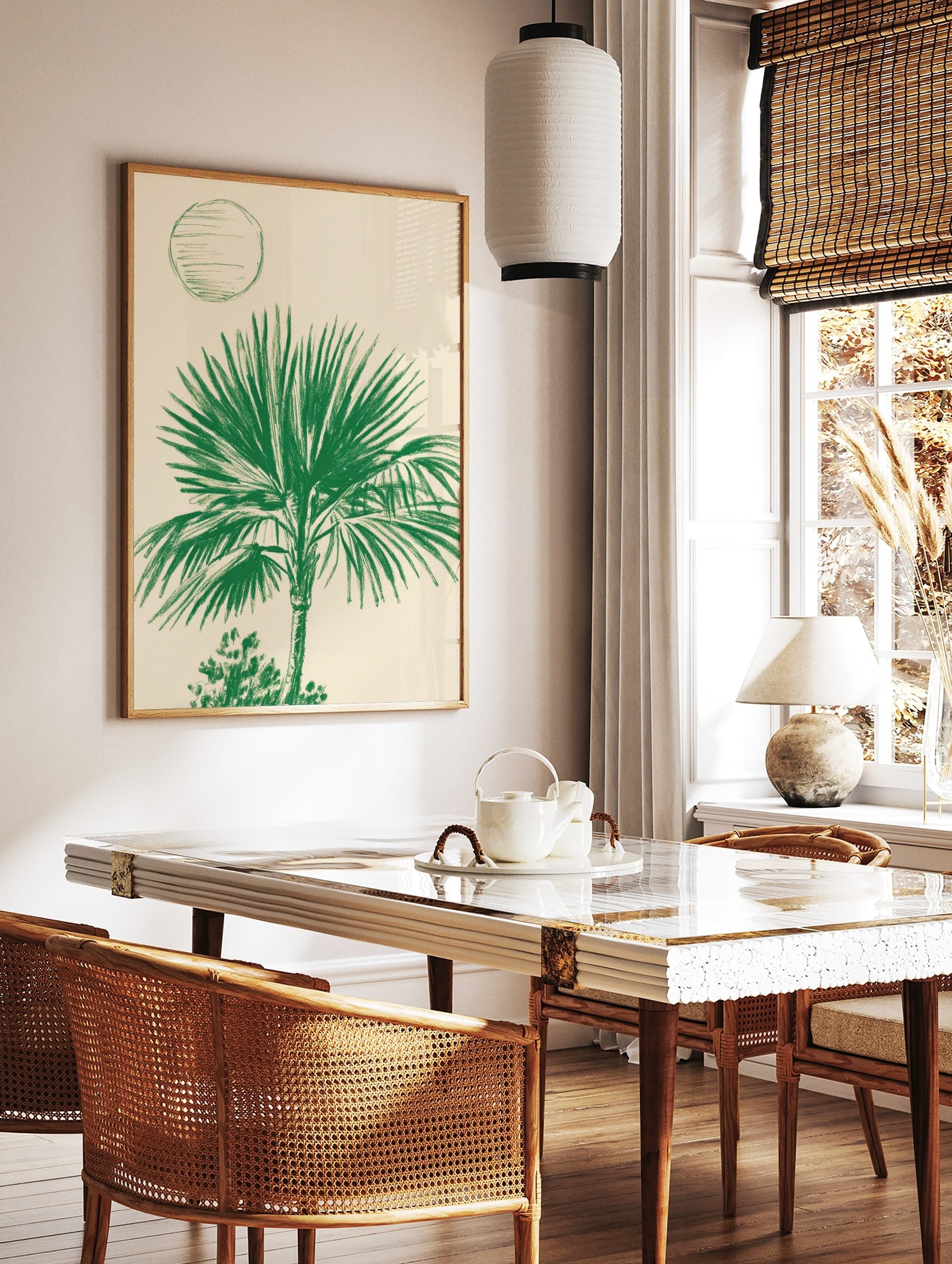 Illustrative green palm tree art print with broad fronds and an abstract circle on a light cream, in a styled room mockup