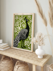 Illustrative black peacock print with white feather details against a textured green, in an alternate framed mockup