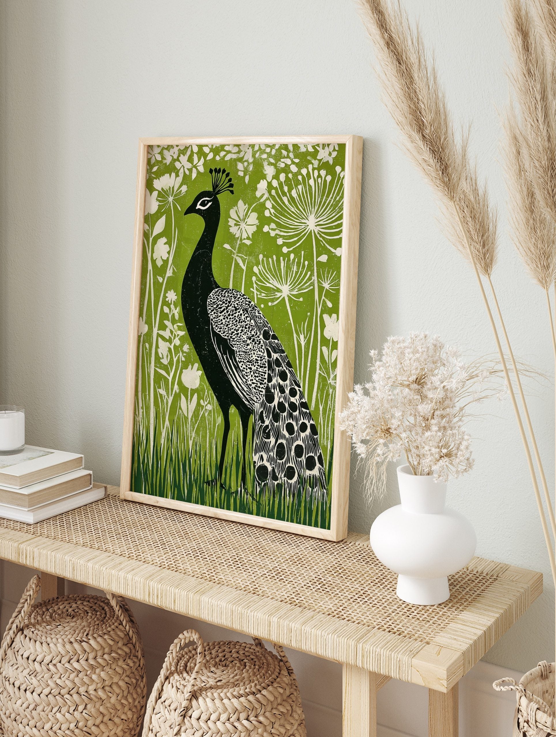 Black peacock with white patterned feathers against a vibrant green background with white, in an alternate framed mockup