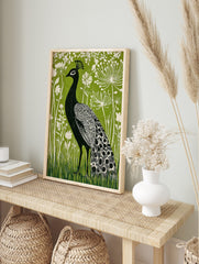 Black peacock with white patterned feathers against a vibrant green background with white, in an alternate framed mockup