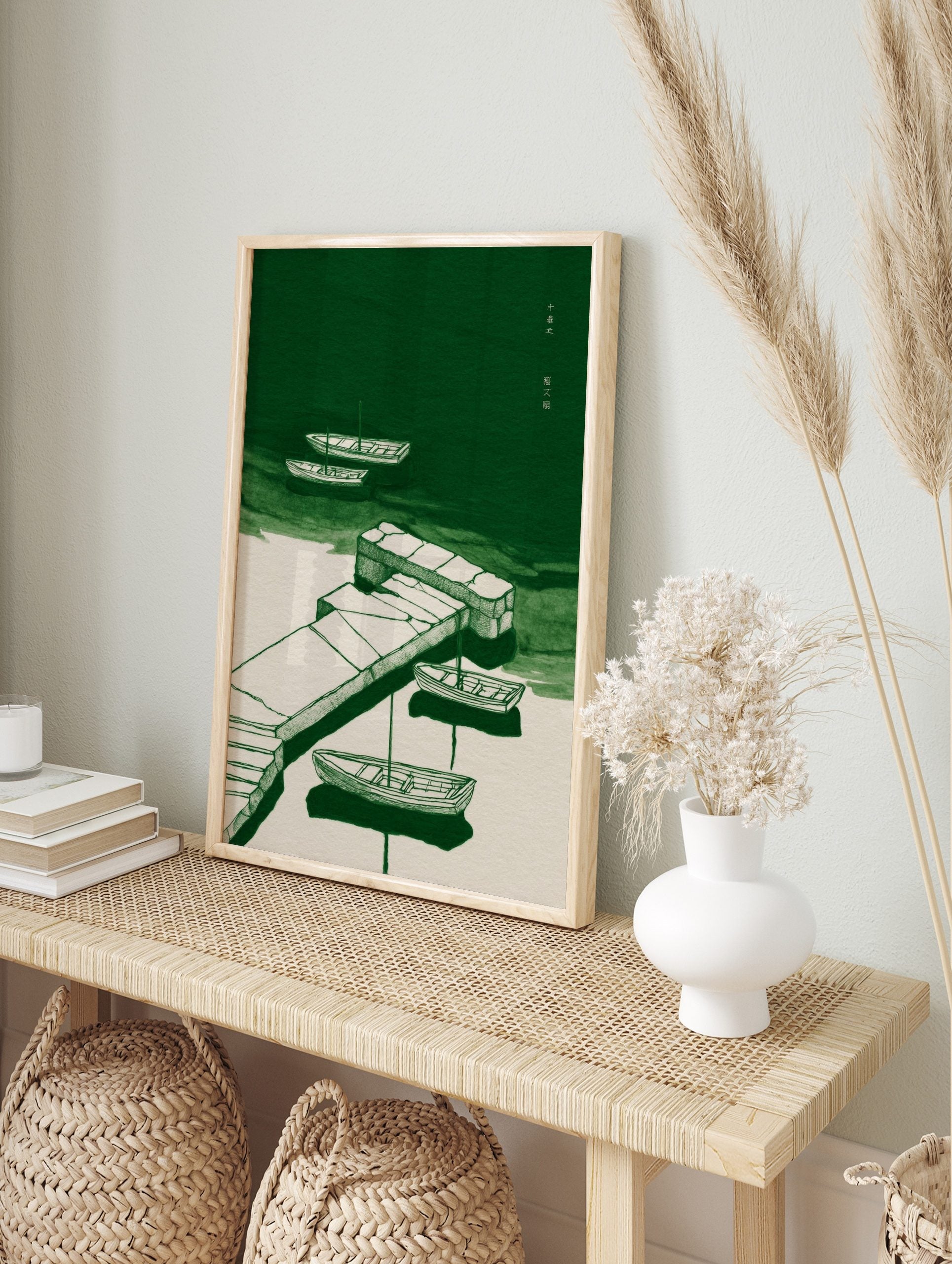 Green and off-white illustration of boats moored to a stone pier on calm water, with Chinese, in an alternate framed mockup