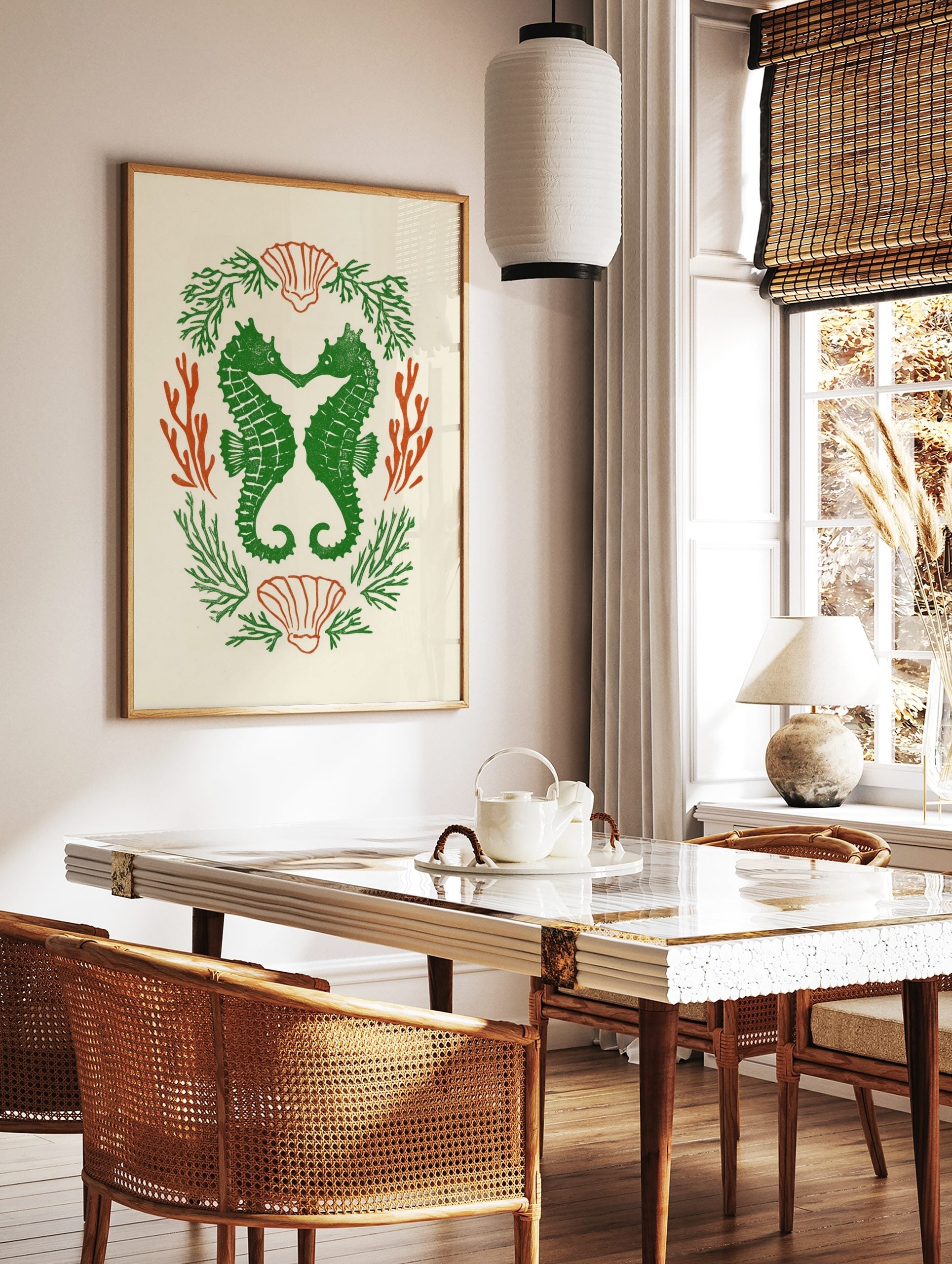 Green seahorses forming a heart, surrounded by orange coral and green seaweed, with scallop shells, in a styled room mockup