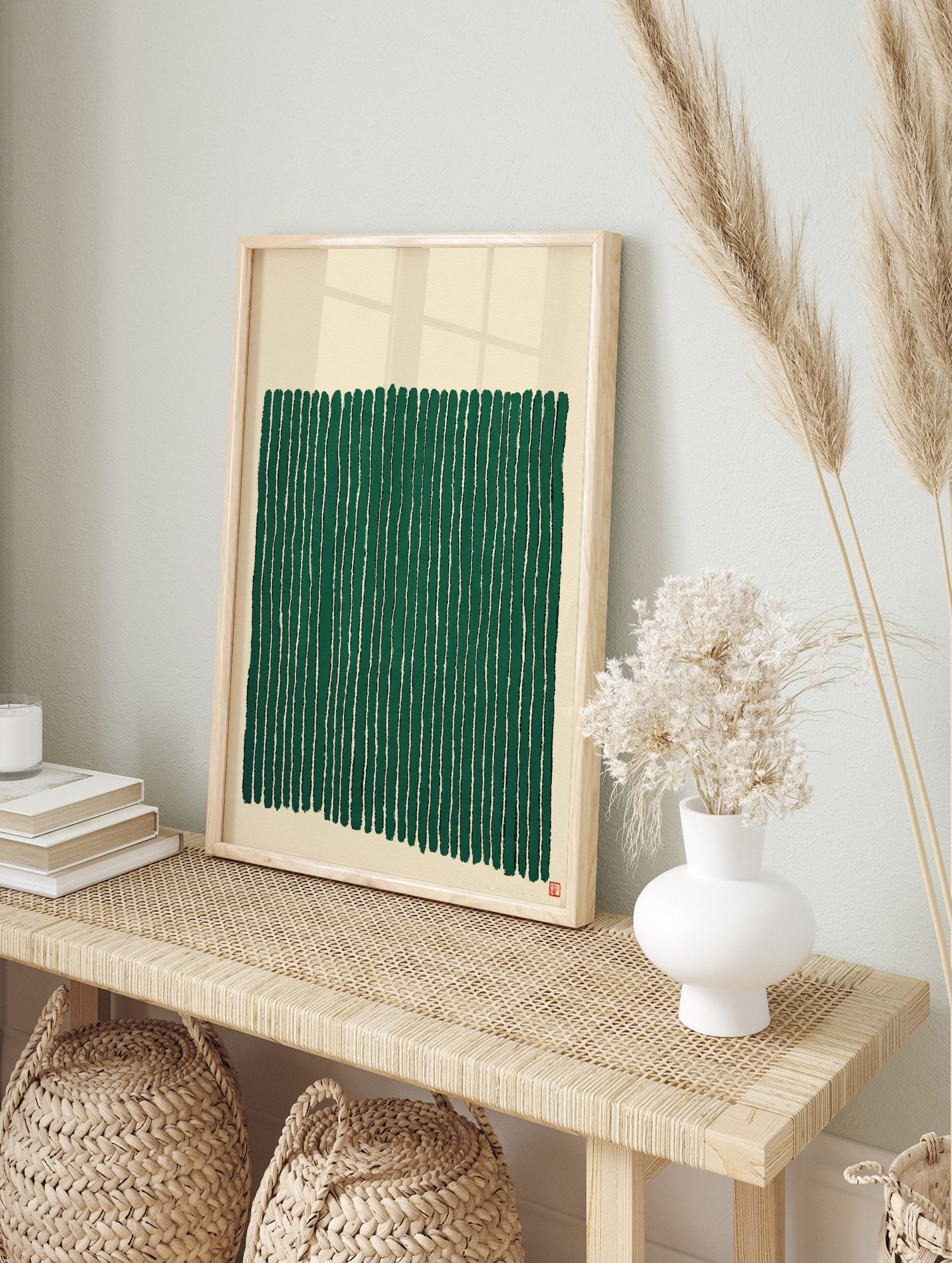 Abstract green vertical stripes wall art on a beige background with a small red seal, in an alternate framed mockup