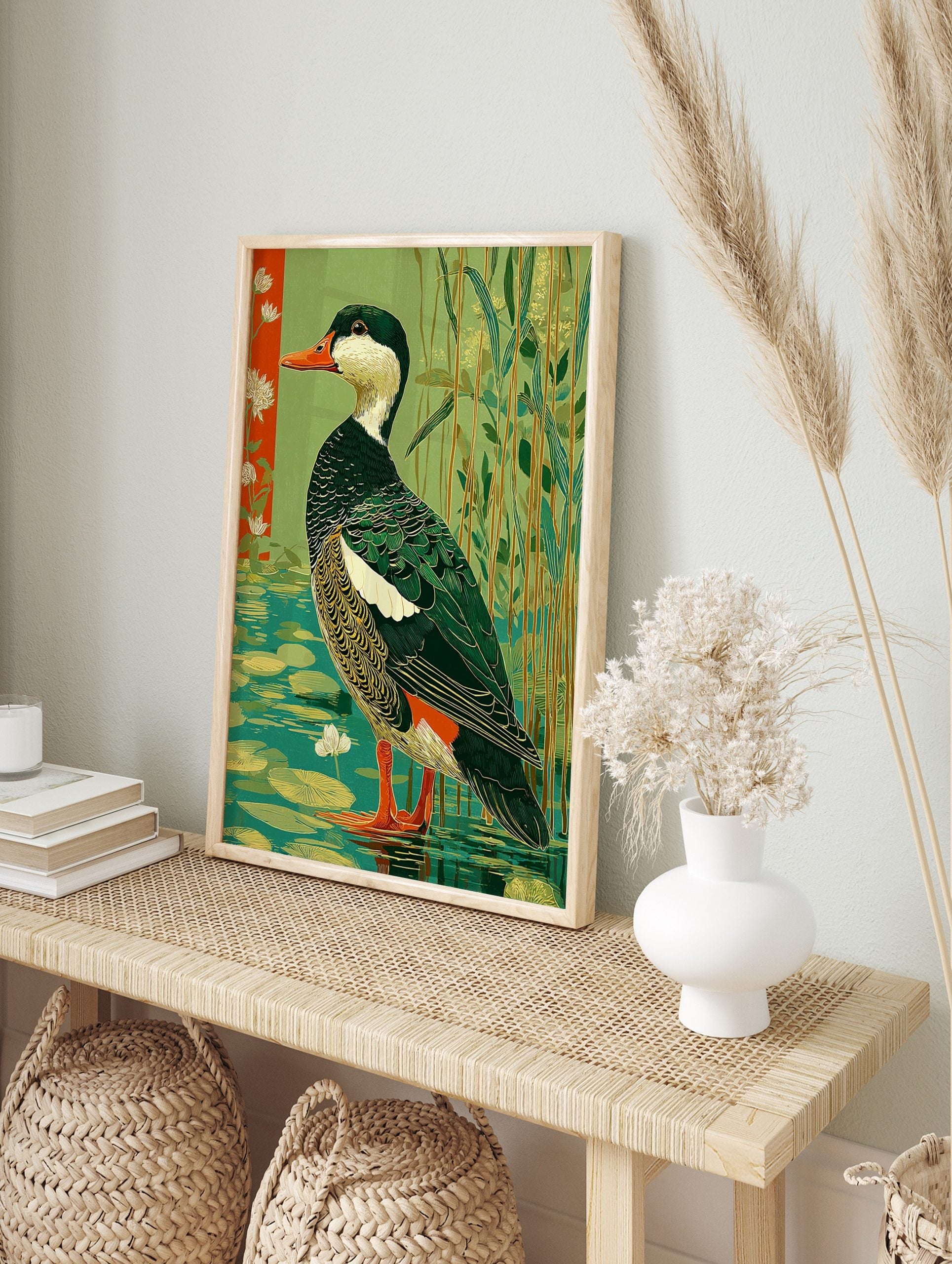 Illustrative green waterfowl duck standing in water with lily pads, reeds, and a red floral, in an alternate framed mockup
