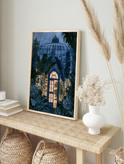 Watercolor illustration of a tropical greenhouse at night with glowing interior light and, in an alternate framed mockup