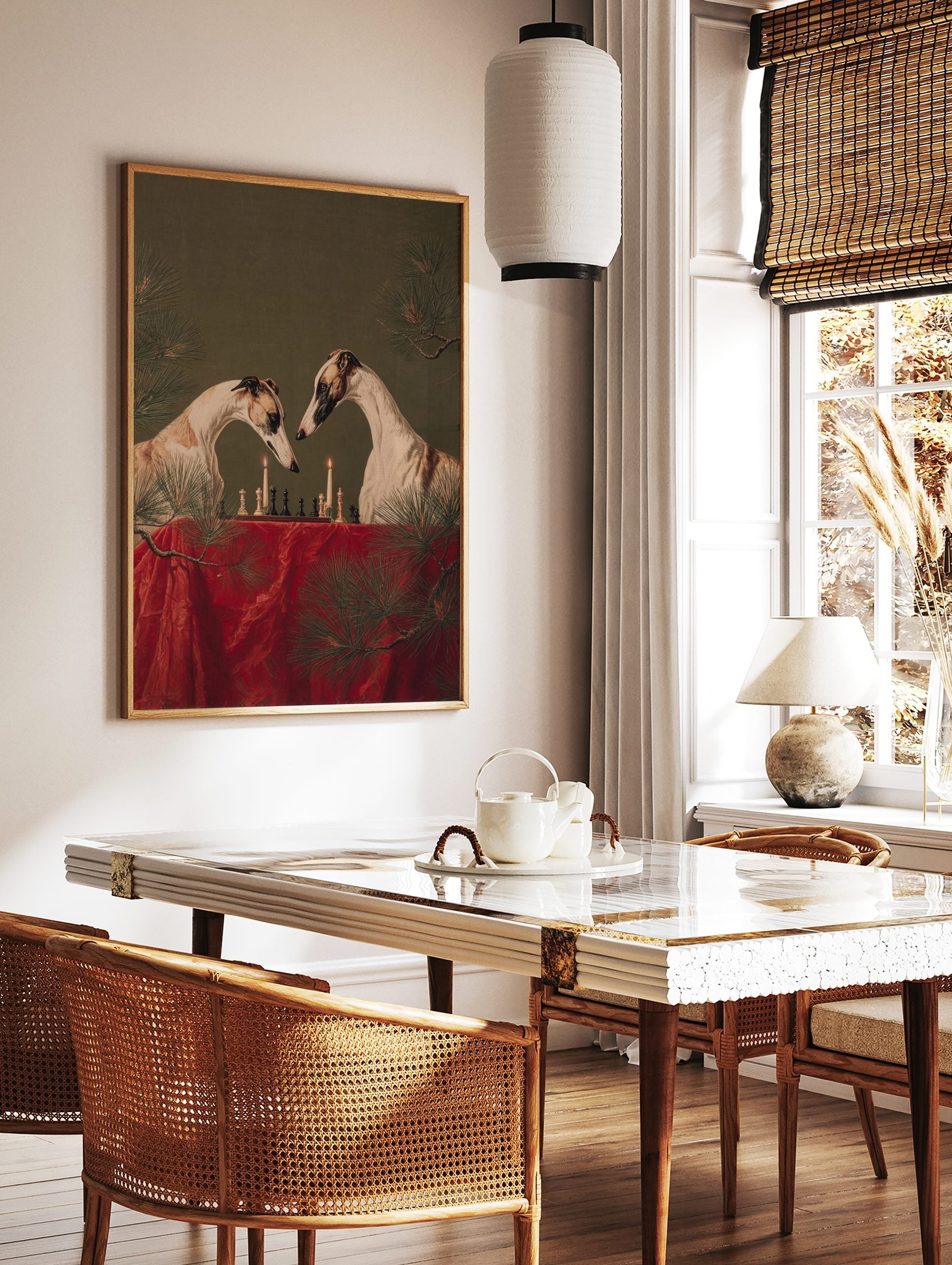 Two greyhounds playing chess by candlelight on a red table, with pine branches, against a green, in a styled room mockup