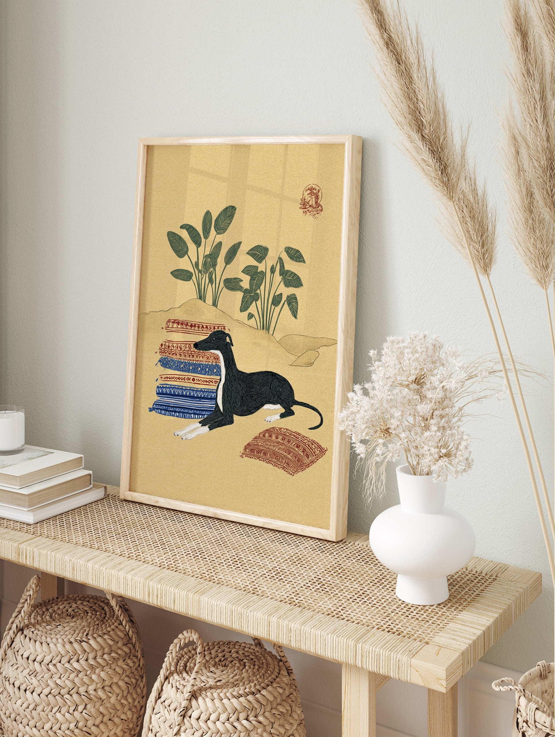 Illustrative art print featuring a black and white Greyhound dog lying on patterned rugs in a desert landscape with green plants. - Image 3