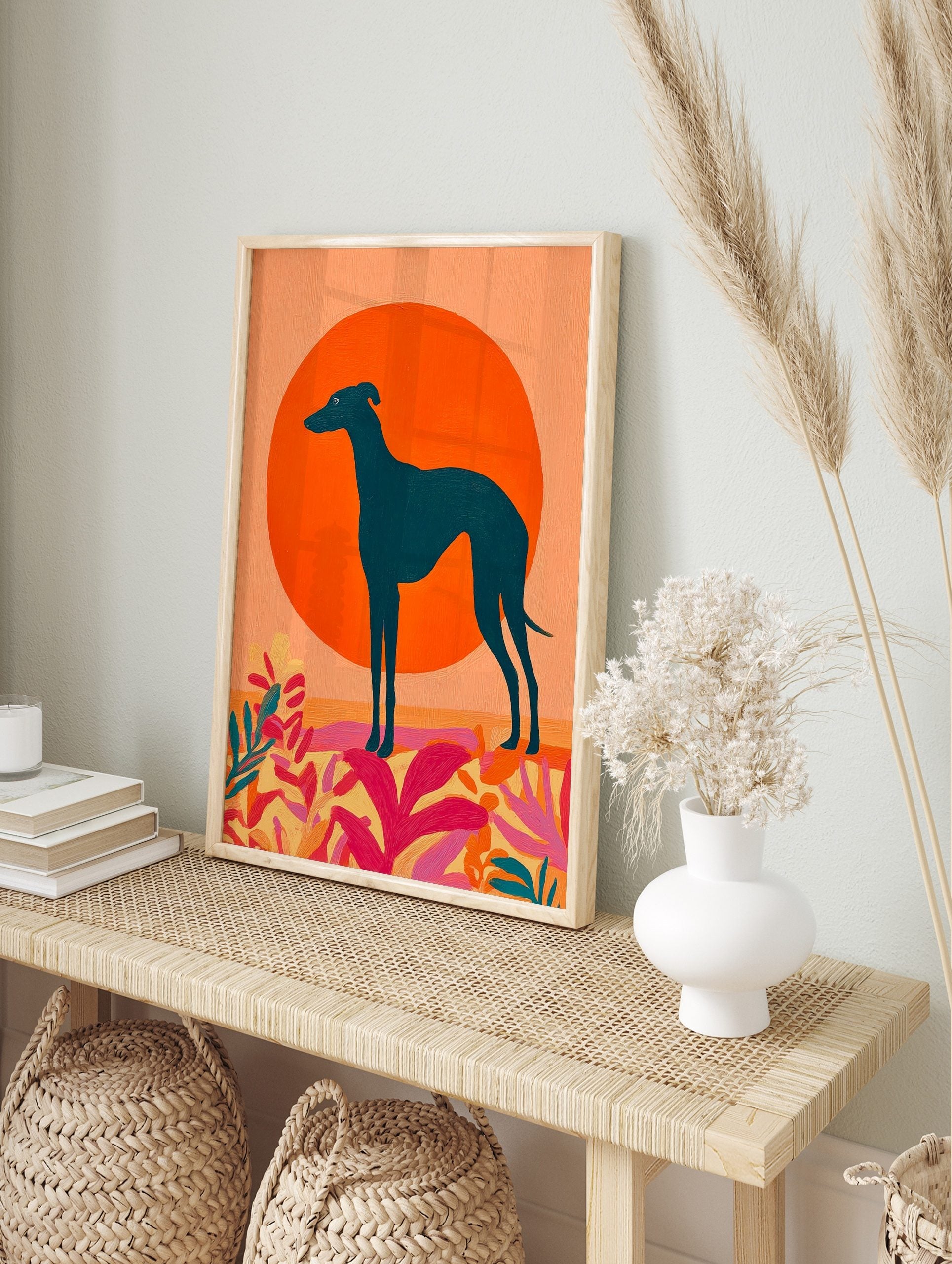 Teal greyhound dog silhouette against a large orange sun with vibrant pink and yellow, in an alternate framed mockup