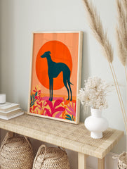 Teal greyhound dog silhouette against a large orange sun with vibrant pink and yellow, in an alternate framed mockup