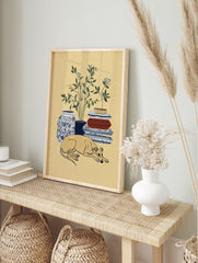 Greyhound wall art print of a sleeping dog with botanical plant, blue vase, and patterned blankets. - Image 3