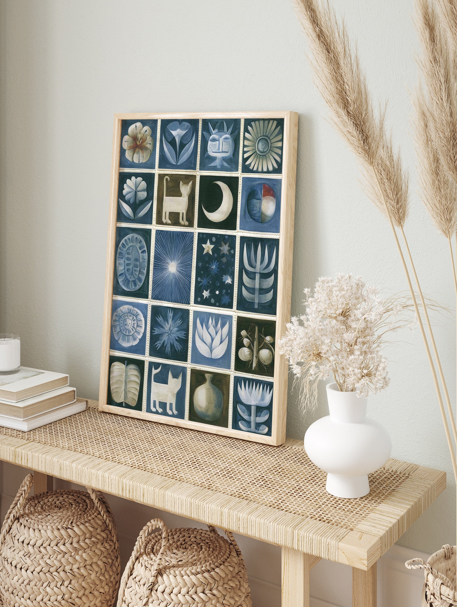 Grid of twenty stylized folk art illustrations featuring cats, flowers, and celestial shapes, in an alternate framed mockup