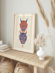 Vertical Hannya mask wall art featuring two Japanese demon masks in red and blue on a, in an alternate framed mockup