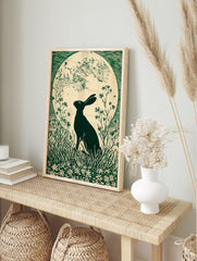 Green linocut print of a hare in silhouette looking at a large full moon, surrounded by grass, in an alternate framed mockup