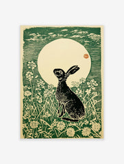 Woodcut print of a black hare looking up at a large cream moon with green sky and white flowers
