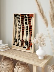 Illustration of five legs in patterned hosiery and high heels, including diamond and swirling, in an alternate framed mockup