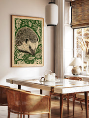 Hedgehog linocut style wall art print with green foliage on a cream background, portrait orientation, in a styled room mockup