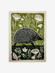 Green and white linocut print of a hedgehog walking through a forest with large leaves and flowers.