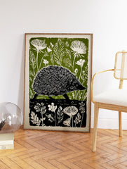 Green and white linocut print of a hedgehog walking through a forest with large leaves and flowers. - Image 2