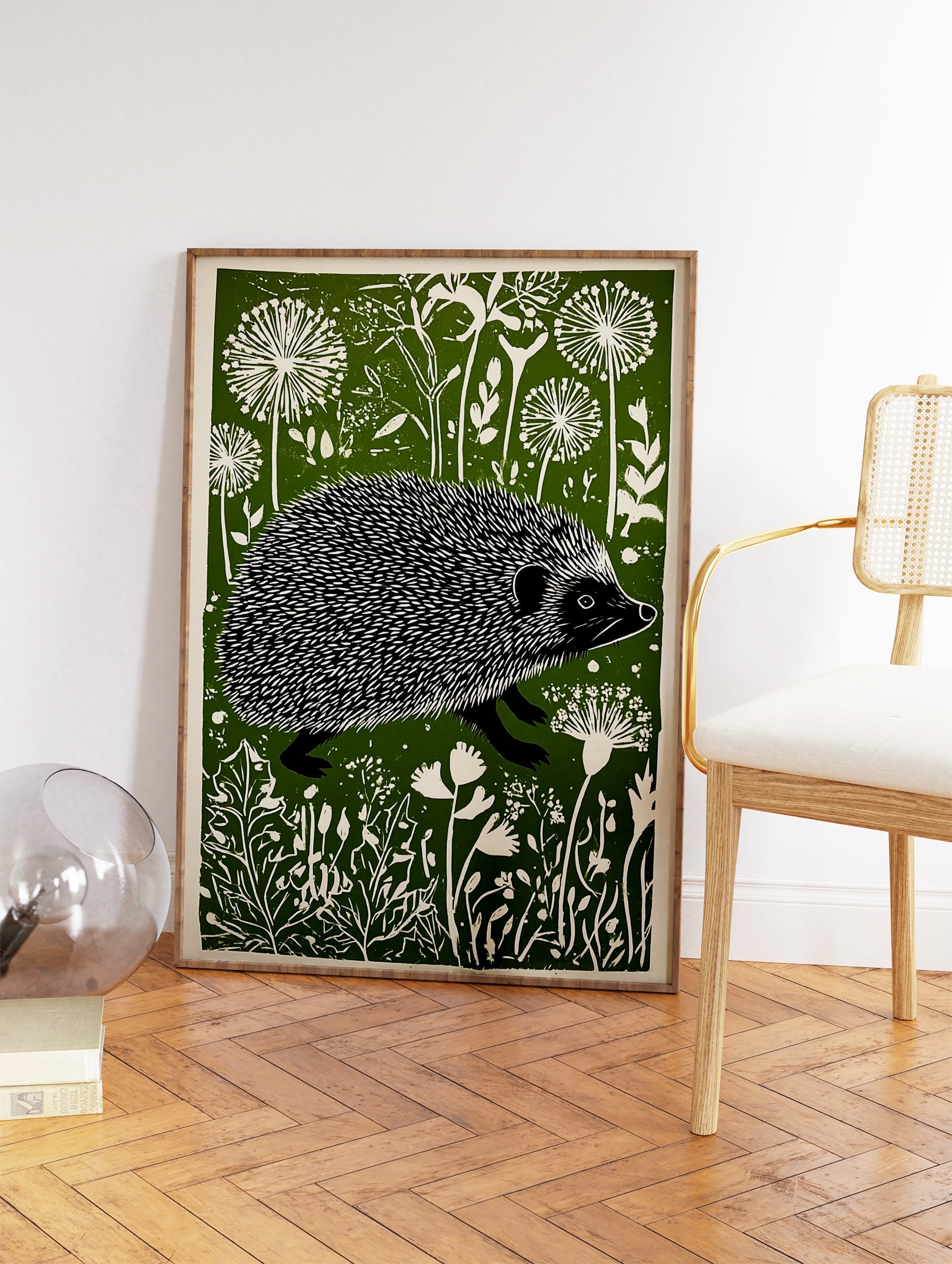 Linocut print of a hedgehog walking through a green and white stylized meadow with dandelion-like flowers. - Image 2