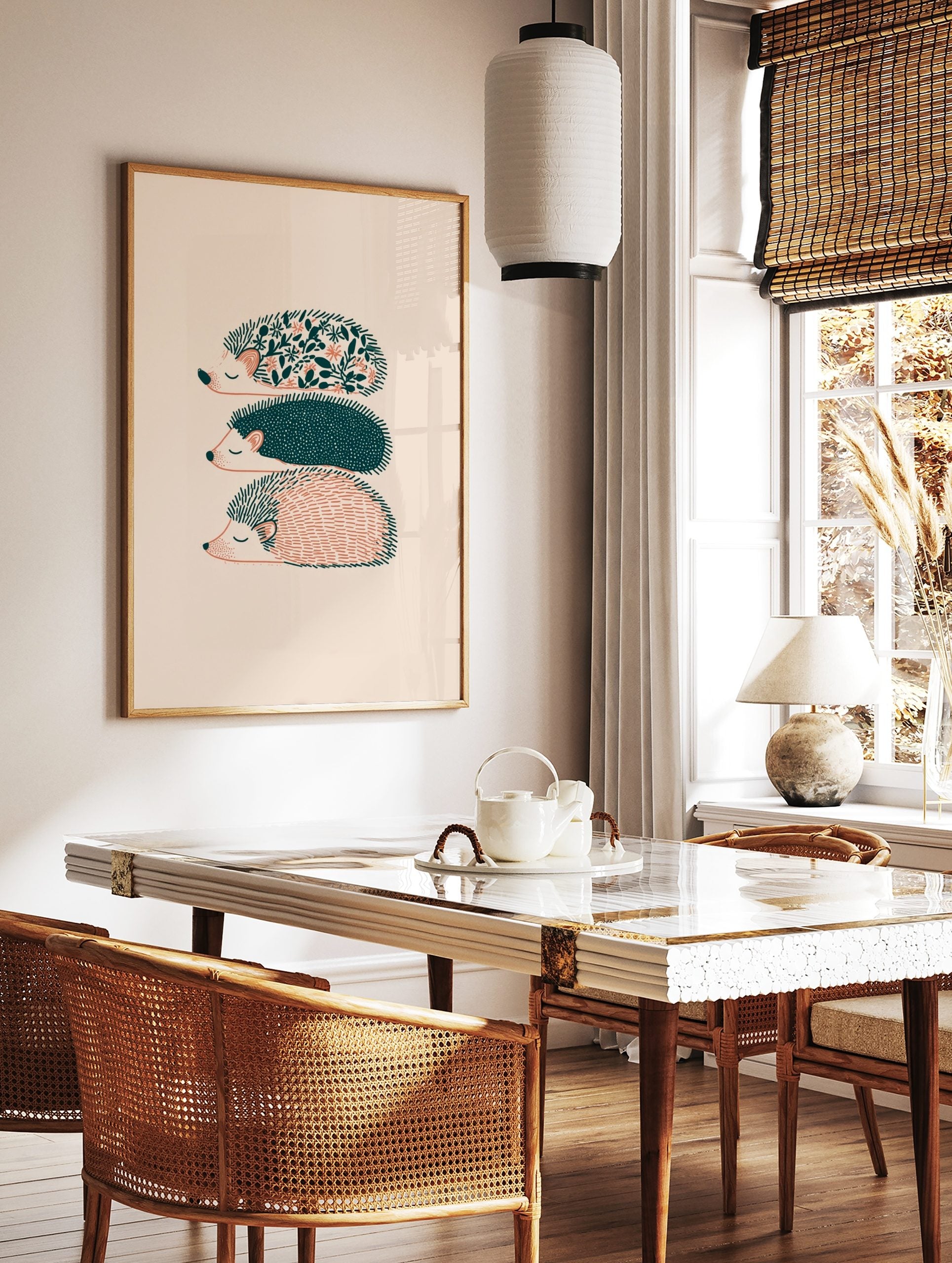 Three illustrative hedgehogs with floral, dotted, and striped patterns in teal and peach on a cream, in a styled room mockup