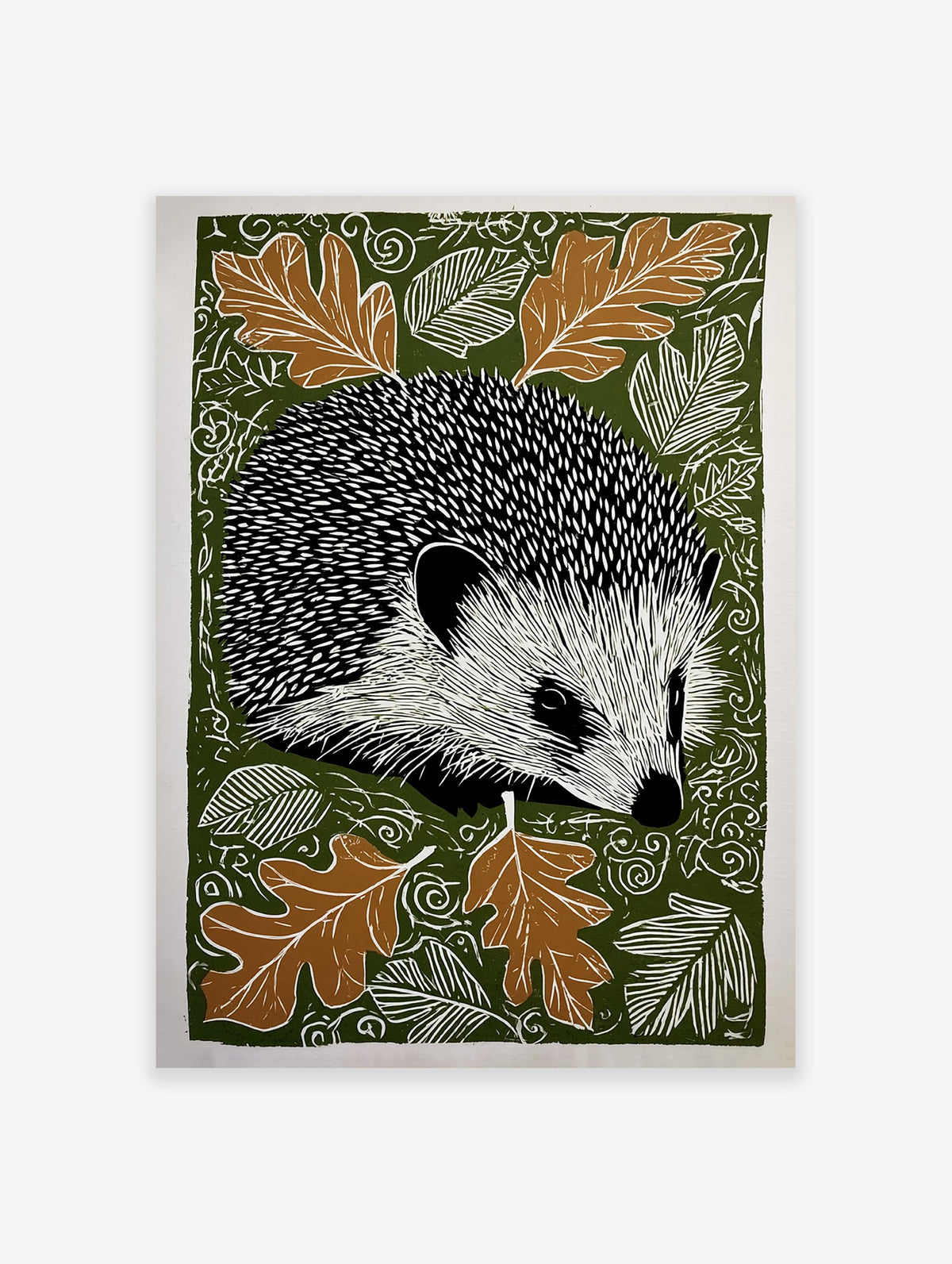 Hedgehog wall art print with black and white hedgehog, brown oak leaves, and white swirling patterns on a dark green background.