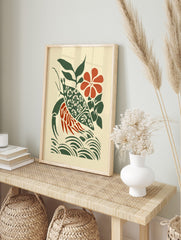 Stylised hermit crab wall art with patterned green shell, red body, green leaves, red flower, in an alternate framed mockup