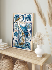 Illustrative white heron bird with blue feathers and golden legs, surrounded by blue flowers, in an alternate framed mockup
