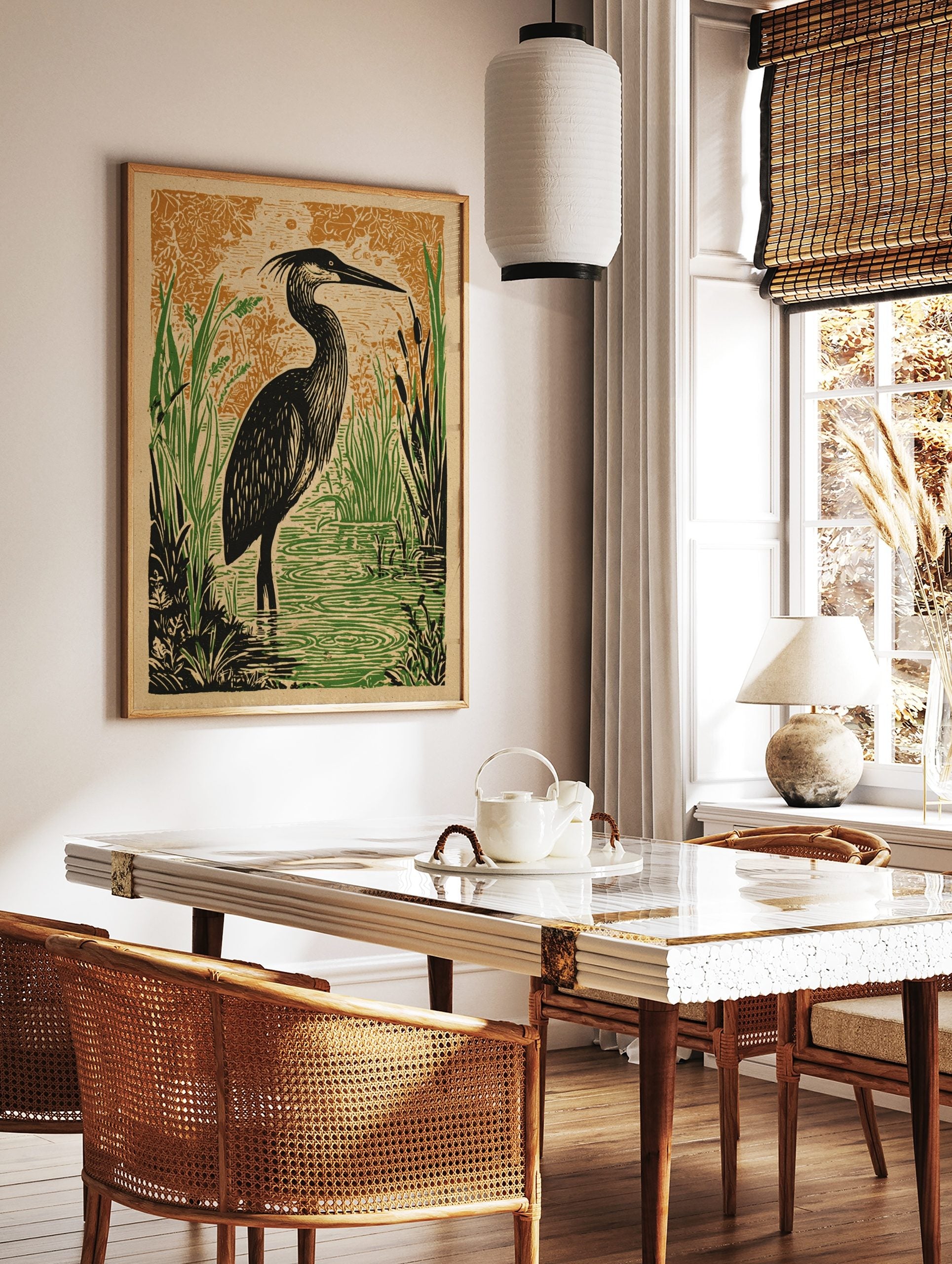Illustrative print of a black heron bird in green wetland reeds and water, with an orange patterned, in a styled room mockup