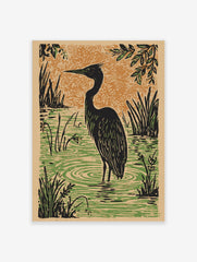 Illustrative black heron wading in green water with reeds, orange textured background in linocut style