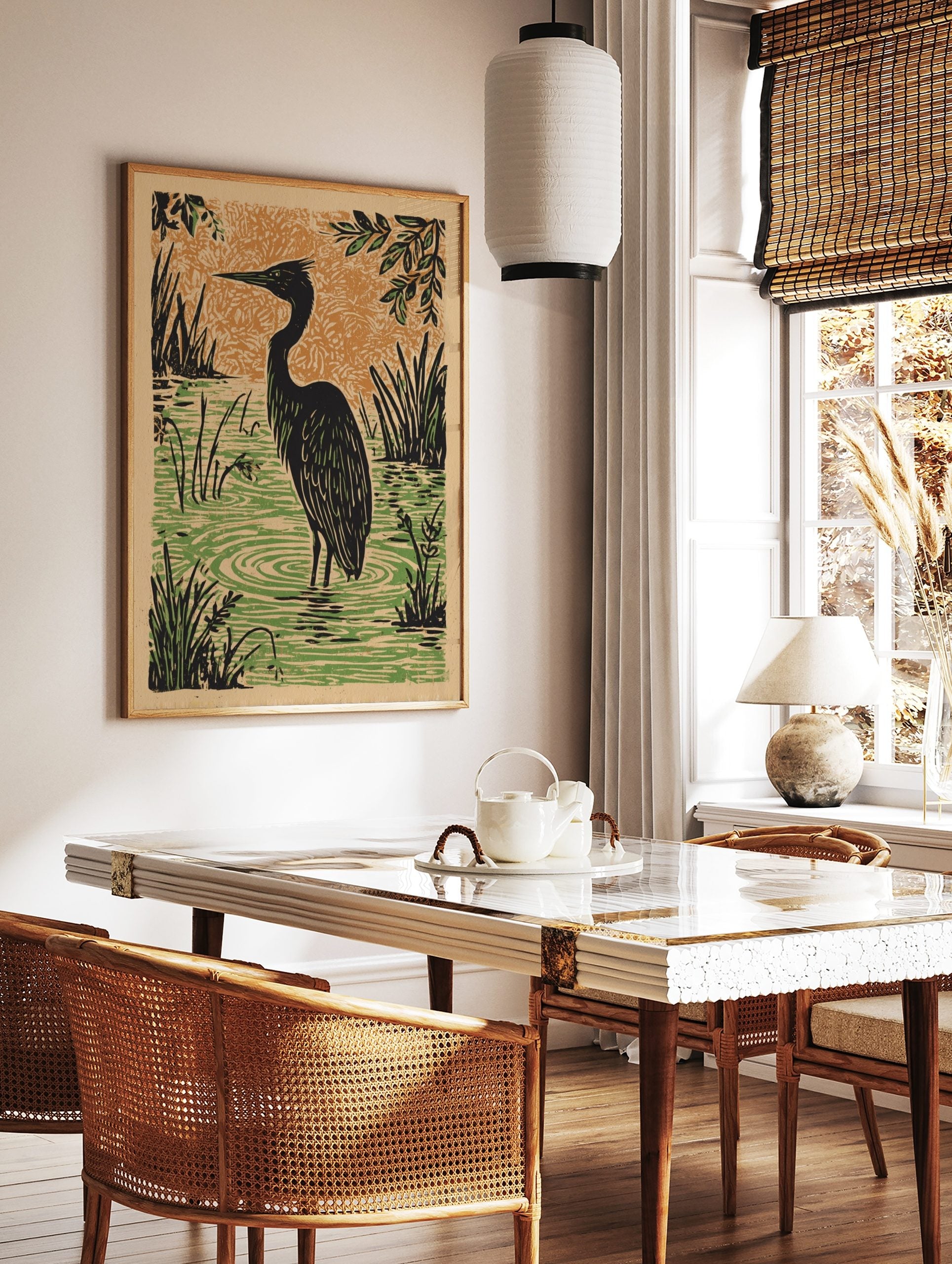 Illustrative black heron wading in green water with reeds, orange textured background in linocut, in a styled room mockup