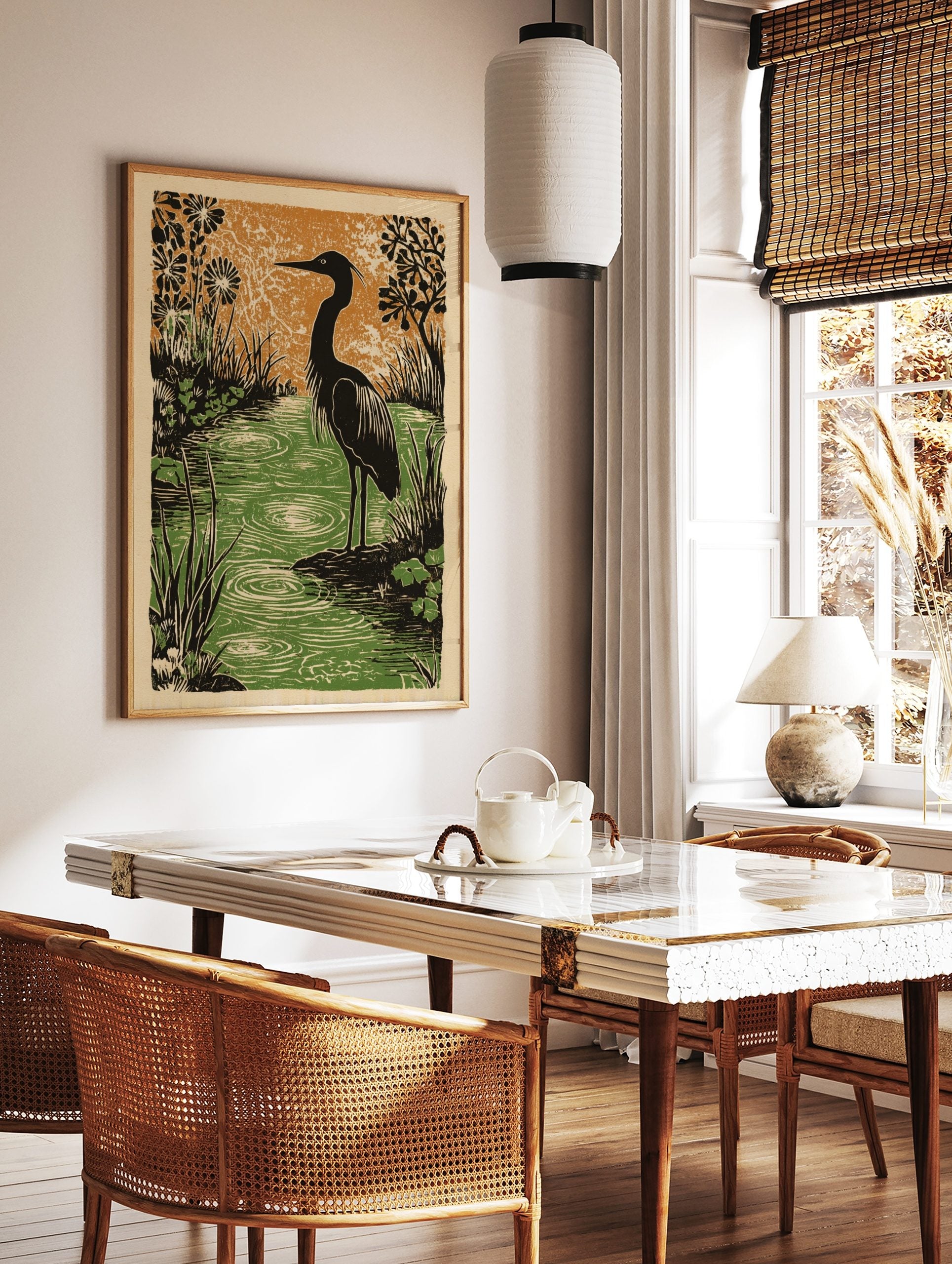 Heron bird standing by rippled green water with black stylised plants and orange background, in a styled room mockup