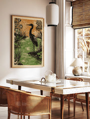 Heron bird standing by rippled green water with black stylised plants and orange background, in a styled room mockup