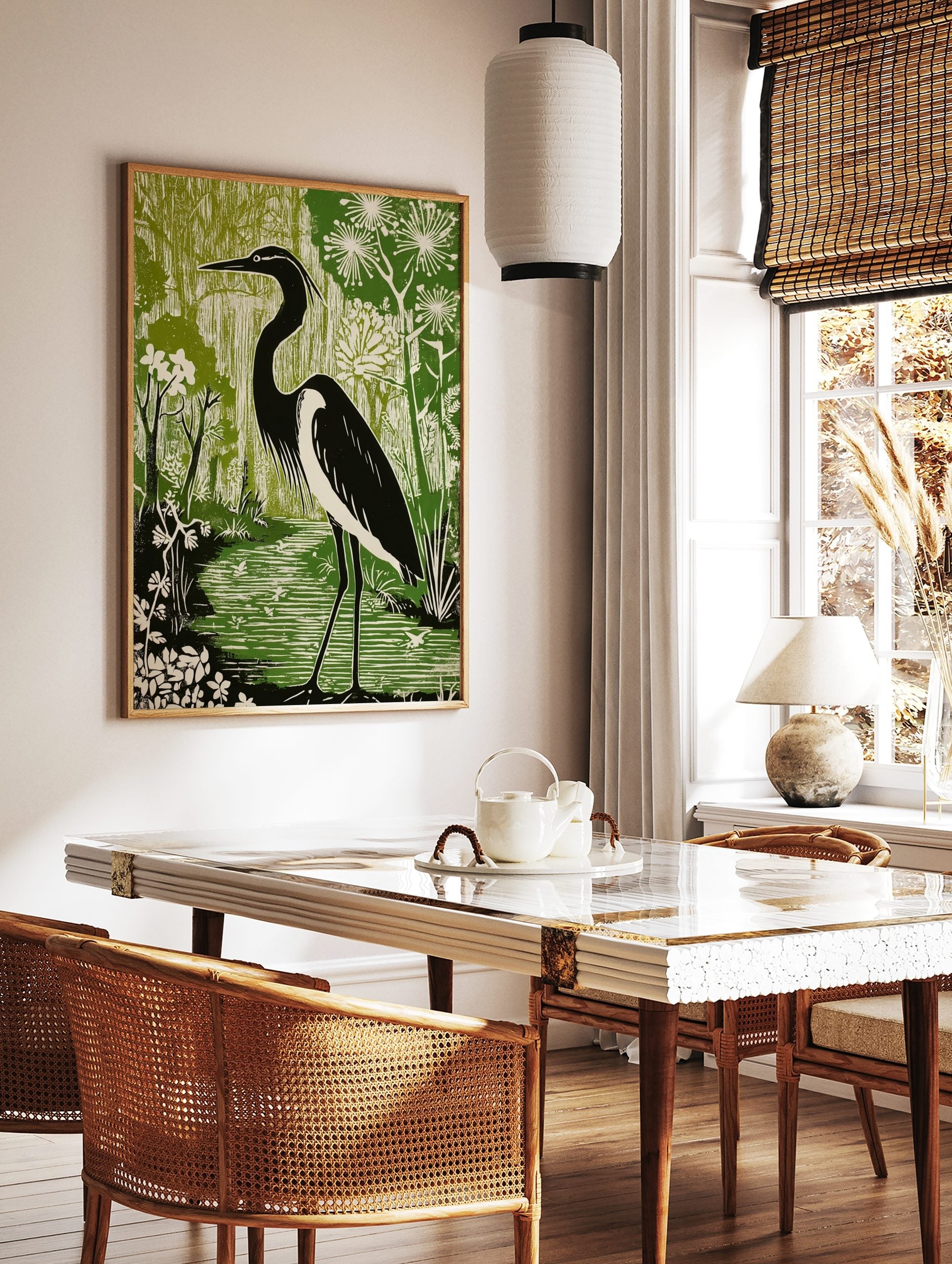 Black and white heron standing in a green wetland with flowering plants, in a linocut style art, in a styled room mockup