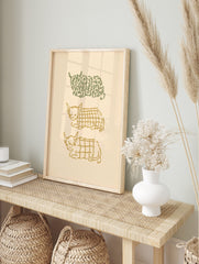 Three stylised Highland cow illustrations, one green botanical and two golden plaid, stacked, in an alternate framed mockup